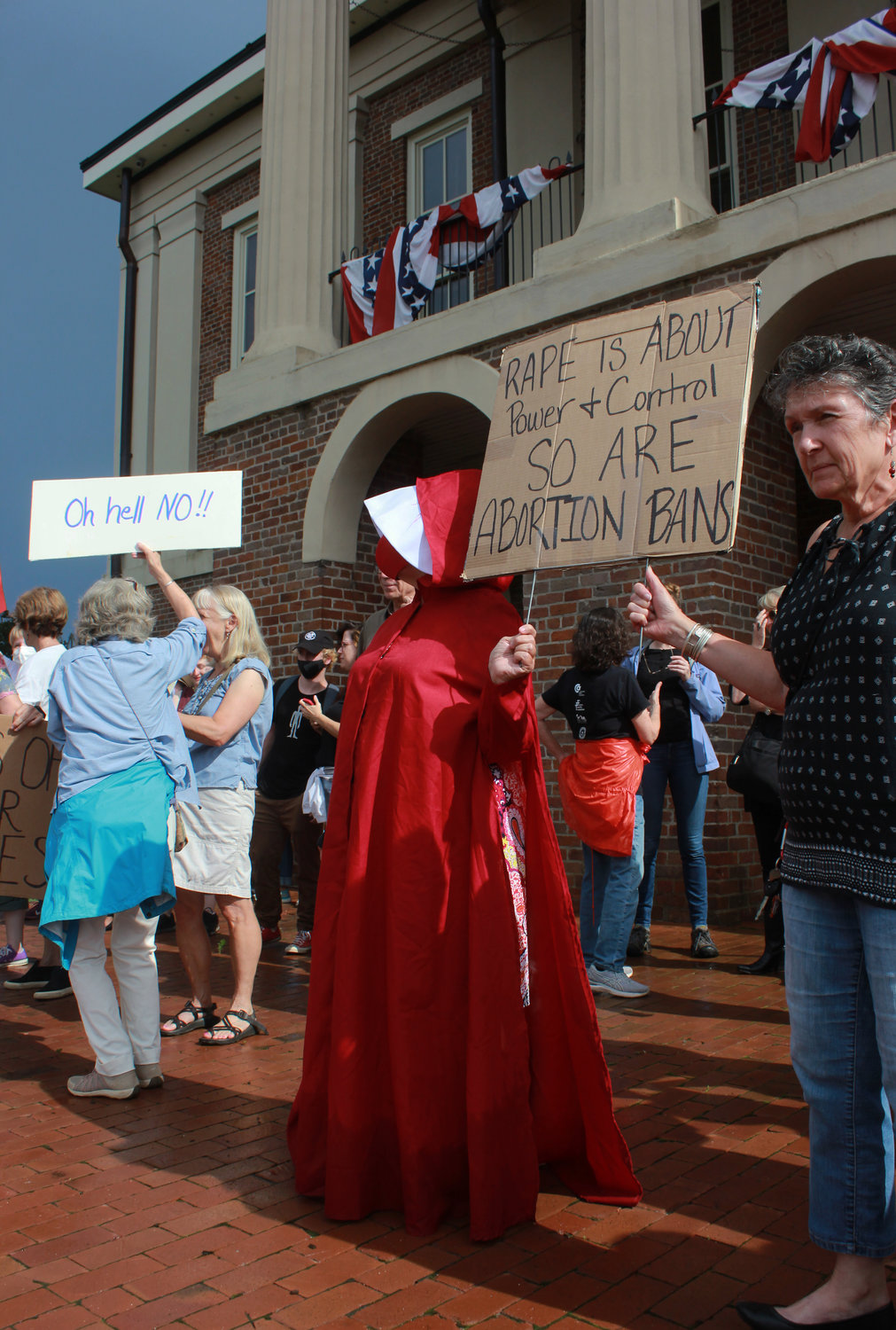 A women dressed as a Handmaid, a repressed female character based on Margaret Atwood’s novel 'The Handmaid’s Tale,' during the abortion and women’s rights protest on Monday at the Historic Courthouse in Pittsboro.
